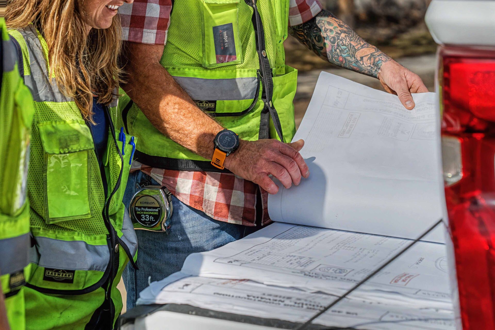 construction workers reviewing blueprints job site