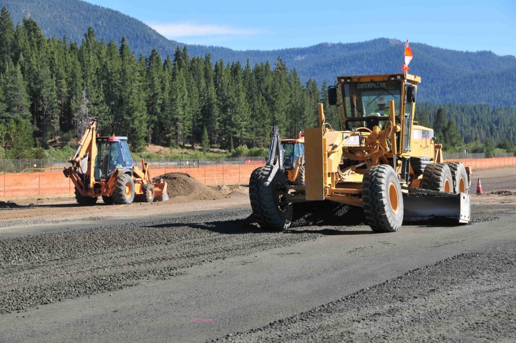 road grading heavy equipment pine forest