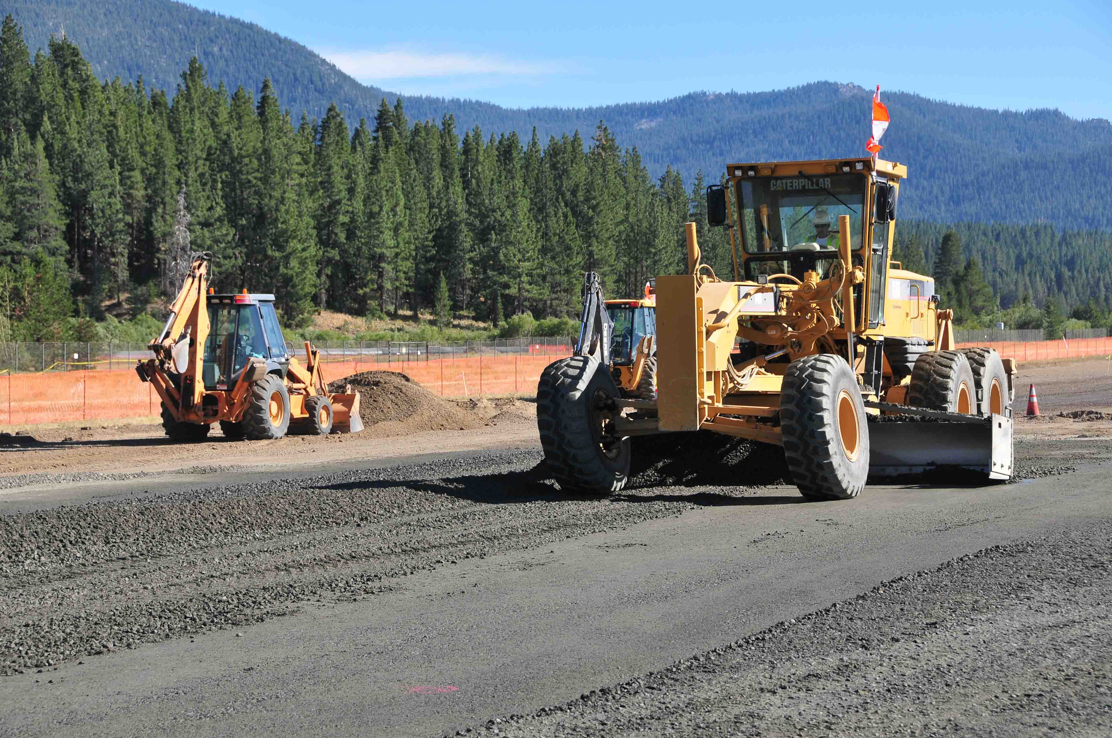 road grading heavy equipment pine forest
